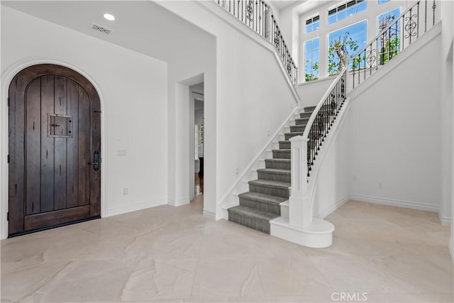 25471 Prado De Oro, Calabasas, CA 91302 - entryway featuring arched walkways, stairway, marble finish floors, and a towering ceiling
