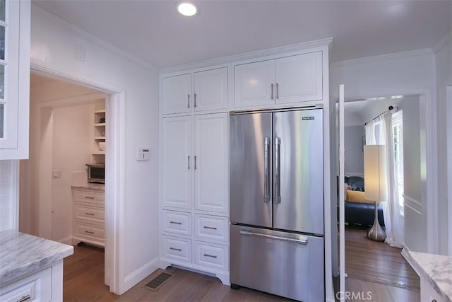 2450 Hermosita Dr, Glendale, CA 91208 - kitchen featuring high end fridge, wood finished floors, white cabinets, ornamental molding, and light stone counters
