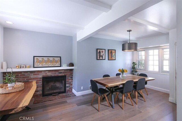 2450 Hermosita Dr, Glendale, CA 91208 - dining space with beam ceiling, wood finished floors, and a fireplace