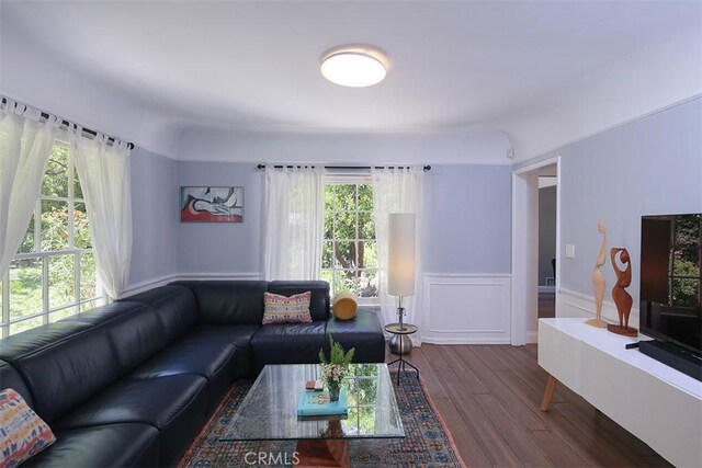 2450 Hermosita Dr, Glendale, CA 91208 - living area featuring wood finished floors, a wainscoted wall, and a decorative wall