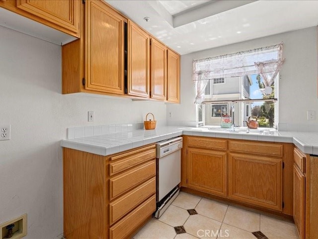 19025 Windridge Ln, Huntington Beach, CA 92646 - kitchen with dishwasher, light tile patterned floors, and brown cabinetry