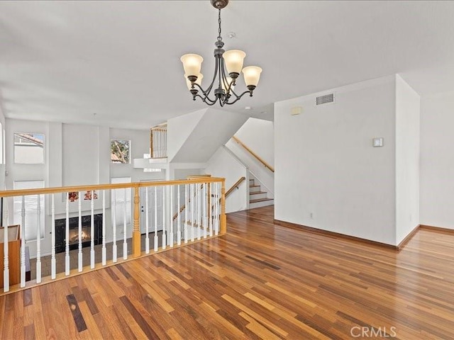 19025 Windridge Ln, Huntington Beach, CA 92646 - unfurnished room featuring wood finished floors and a chandelier