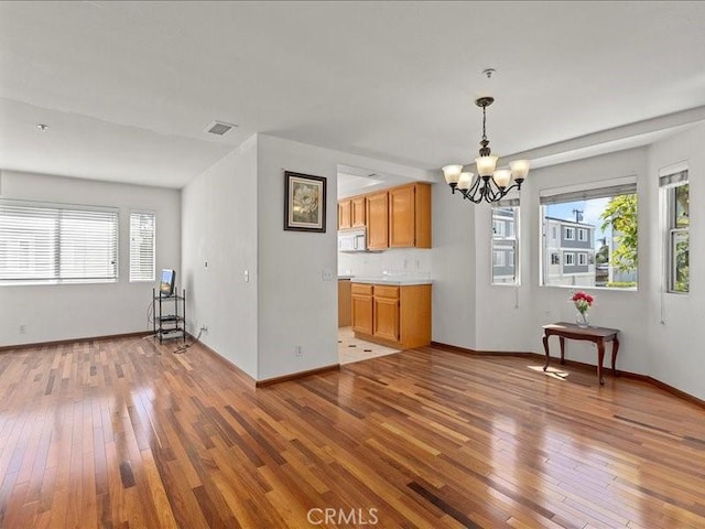19025 Windridge Ln, Huntington Beach, CA 92646 - unfurnished dining area with a chandelier and wood-type flooring