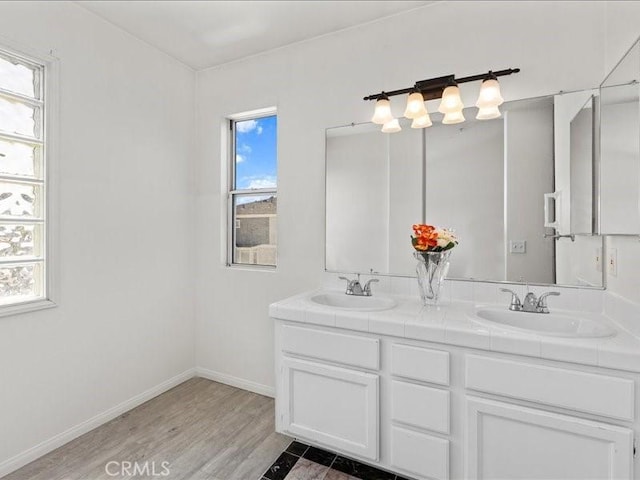19025 Windridge Ln, Huntington Beach, CA 92646 - full bathroom featuring double vanity and wood finished floors