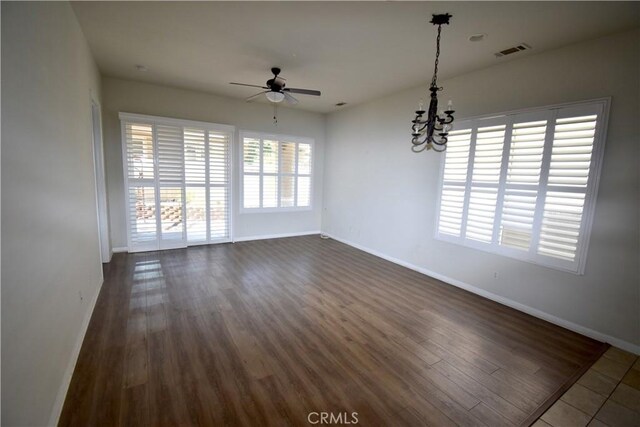 19485 Tor Hill Ln, Apple Valley, CA 92308 - empty room featuring ceiling fan, a chandelier, and dark wood finished floors