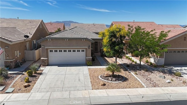 19485 Tor Hill Ln, Apple Valley, CA 92308 - view of front of home with an attached garage, a tile roof, stucco siding, concrete driveway, and a mountain view