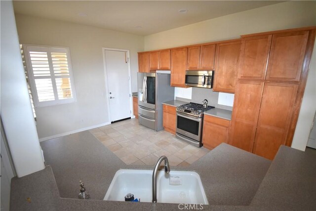 19485 Tor Hill Ln, Apple Valley, CA 92308 - kitchen featuring stainless steel appliances and brown cabinetry