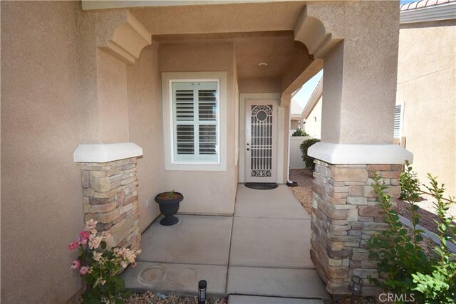 19485 Tor Hill Ln, Apple Valley, CA 92308 - property entrance featuring stucco siding and a patio
