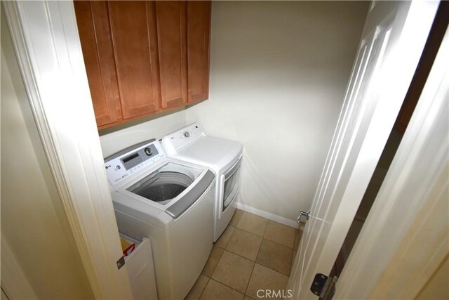 19485 Tor Hill Ln, Apple Valley, CA 92308 - laundry room with washing machine and clothes dryer, light tile patterned floors, and cabinet space
