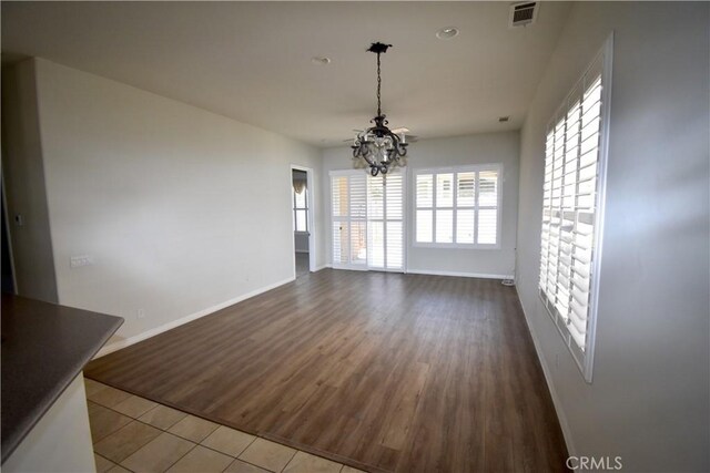 19485 Tor Hill Ln, Apple Valley, CA 92308 - unfurnished dining area with a chandelier, plenty of natural light, and dark wood-style floors