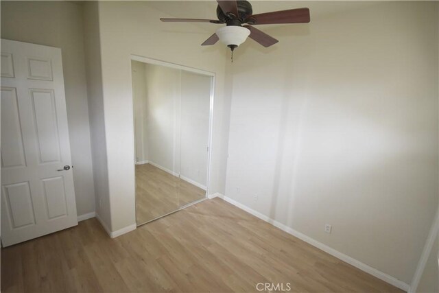 19485 Tor Hill Ln, Apple Valley, CA 92308 - unfurnished bedroom with a closet, light wood-style flooring, and ceiling fan
