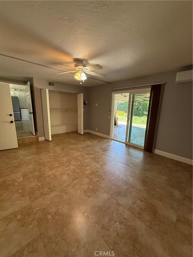 4561 Mimosa Dr, Yorba Linda, CA 92886 - unfurnished living room featuring ceiling fan, an AC wall unit, and a textured ceiling