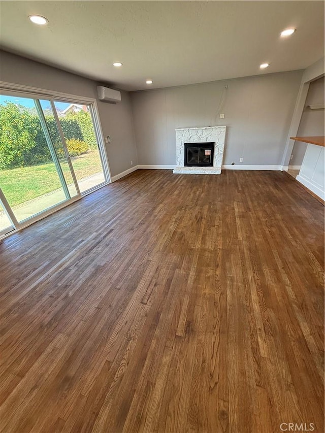 4561 Mimosa Dr, Yorba Linda, CA 92886 - unfurnished living room featuring a wall mounted air conditioner, a high end fireplace, dark wood-type flooring, and recessed lighting