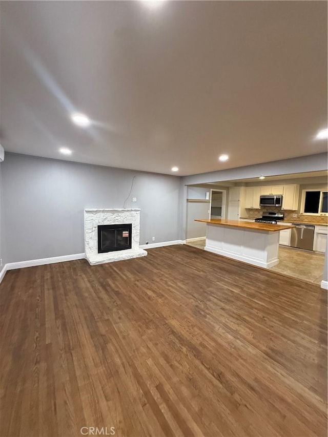 4561 Mimosa Dr, Yorba Linda, CA 92886 - unfurnished living room featuring a stone fireplace, wood finished floors, and recessed lighting