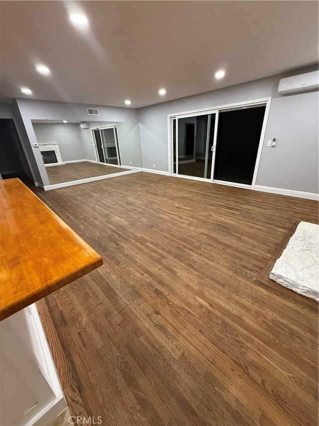 4561 Mimosa Dr, Yorba Linda, CA 92886 - unfurnished living room with a wall mounted air conditioner, a fireplace, wood finished floors, and recessed lighting