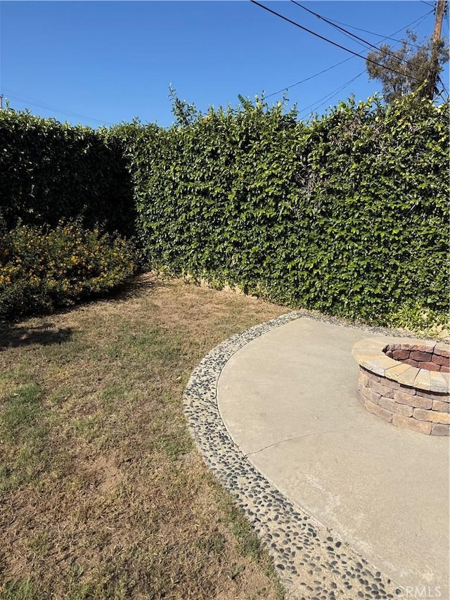 4561 Mimosa Dr, Yorba Linda, CA 92886 - view of grassy yard featuring an outdoor fire pit and a patio area