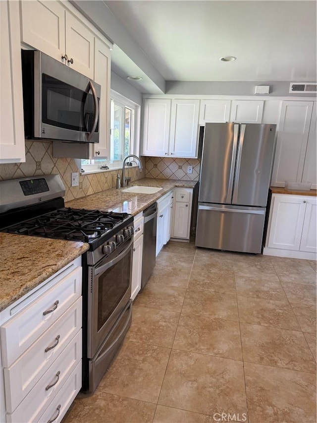 4561 Mimosa Dr, Yorba Linda, CA 92886 - kitchen with stainless steel appliances, white cabinets, decorative backsplash, light stone countertops, and light tile patterned floors