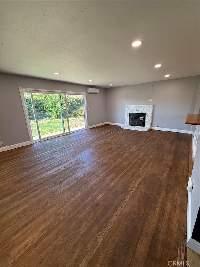 4561 Mimosa Dr, Yorba Linda, CA 92886 - unfurnished living room featuring a wall mounted air conditioner, dark wood-style flooring, recessed lighting, and a glass covered fireplace
