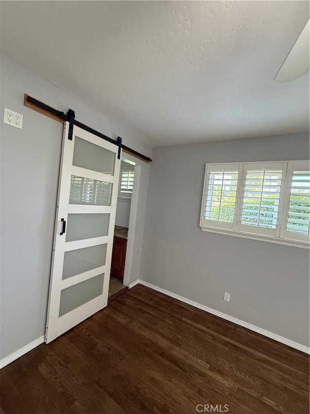 4561 Mimosa Dr, Yorba Linda, CA 92886 - empty room with a barn door and dark wood-style flooring