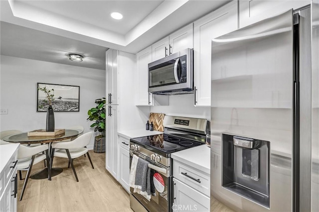 25611 Quail Run Unit 77, Dana Point, CA 92629 - kitchen featuring stainless steel appliances, light countertops, light wood finished floors, white cabinets, and recessed lighting