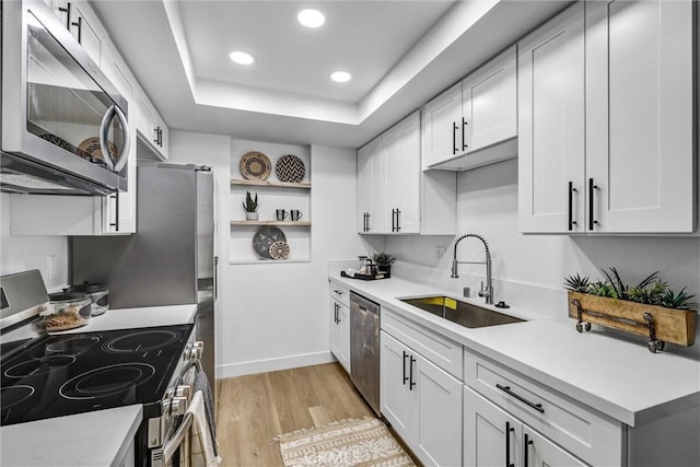 25611 Quail Run Unit 77, Dana Point, CA 92629 - kitchen featuring appliances with stainless steel finishes, light wood-style floors, light countertops, recessed lighting, and white cabinetry