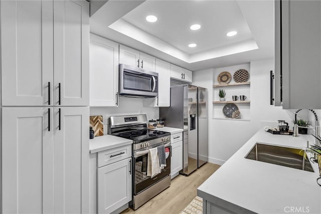 25611 Quail Run Unit 77, Dana Point, CA 92629 - kitchen featuring stainless steel appliances, light countertops, a raised ceiling, light wood-style flooring, and recessed lighting