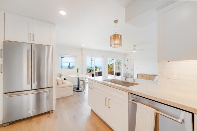 231 5th St, Encinitas, CA 92024 - kitchen featuring stainless steel appliances, light wood-type flooring, white cabinets, light countertops, and recessed lighting