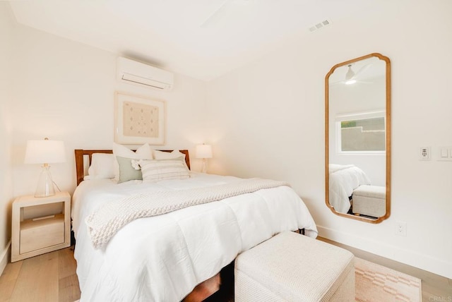 231 5th St, Encinitas, CA 92024 - bedroom featuring an AC wall unit and wood finished floors