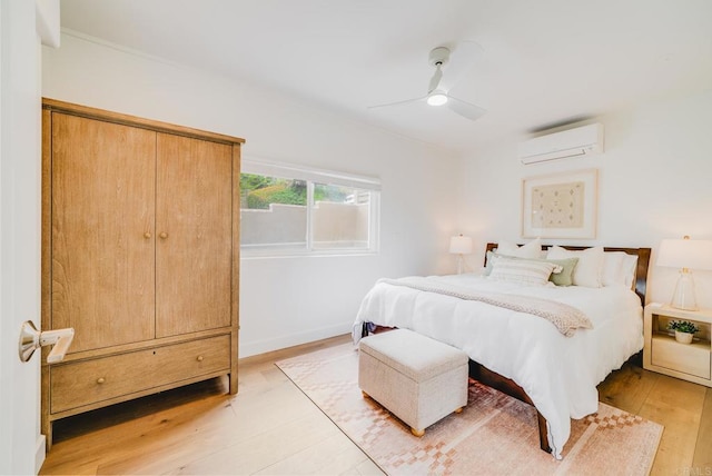 231 5th St, Encinitas, CA 92024 - bedroom featuring an AC wall unit, light wood-type flooring, and a ceiling fan