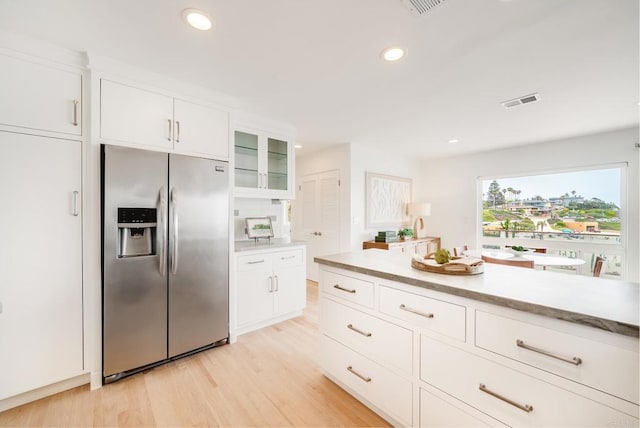 231 5th St, Encinitas, CA 92024 - kitchen with stainless steel fridge with ice dispenser, light countertops, light wood-style floors, glass insert cabinets, and white cabinetry