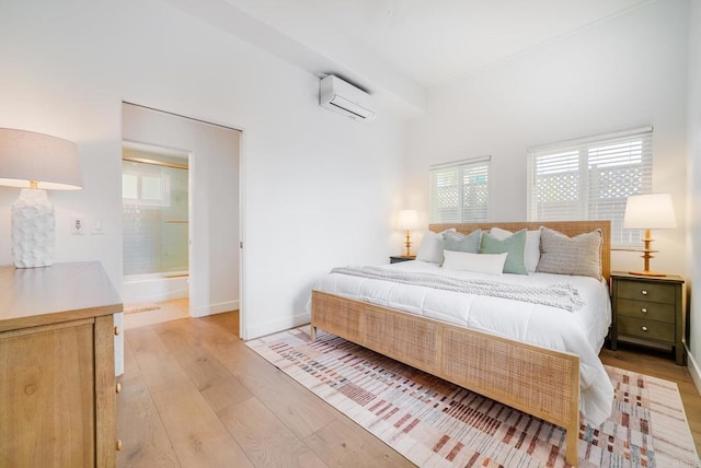 231 5th St, Encinitas, CA 92024 - bedroom with a wall mounted AC and light wood finished floors
