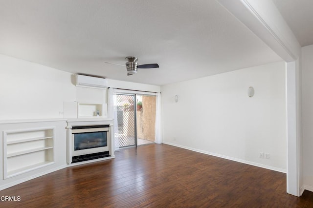 365 Burchett St Unit 112, Glendale, CA 91203 - unfurnished living room featuring a ceiling fan, an AC wall unit, a glass covered fireplace, dark wood-style flooring, and built in features