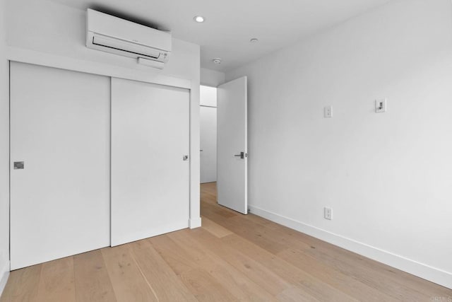 2052 Montgomery Ave, Cardiff By The Sea, CA 92007 - unfurnished bedroom featuring a wall mounted air conditioner, light wood-style flooring, a closet, and recessed lighting