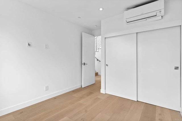 2052 Montgomery Ave, Cardiff By The Sea, CA 92007 - unfurnished bedroom featuring a wall unit AC, light wood-style floors, recessed lighting, and a closet
