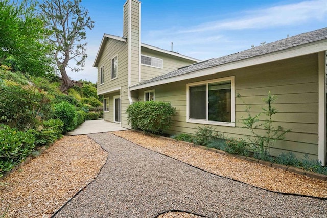 915 Lake Ridge Dr, San Marcos, CA 92078 - view of side of home with a chimney and a patio area