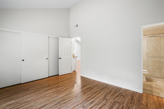915 Lake Ridge Dr, San Marcos, CA 92078 - unfurnished bedroom with wood finished floors, high vaulted ceiling, ensuite bath, and a closet