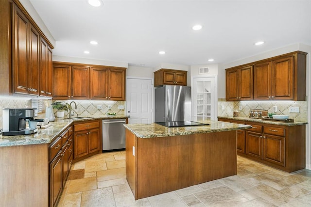 915 Lake Ridge Dr, San Marcos, CA 92078 - kitchen with appliances with stainless steel finishes, a kitchen island, light stone counters, decorative backsplash, and recessed lighting