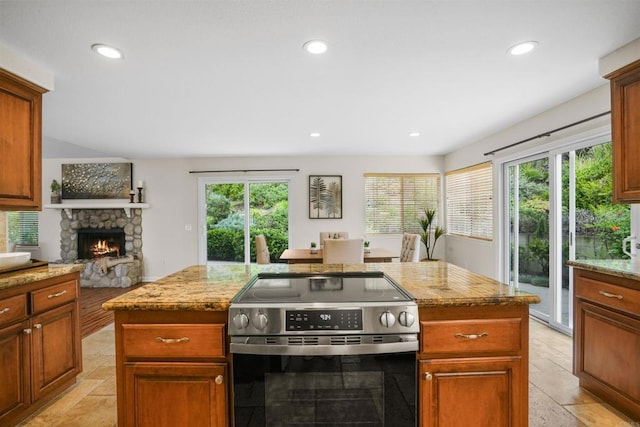 915 Lake Ridge Dr, San Marcos, CA 92078 - kitchen featuring stainless steel range with electric stovetop, a stone fireplace, light stone counters, recessed lighting, and a kitchen island