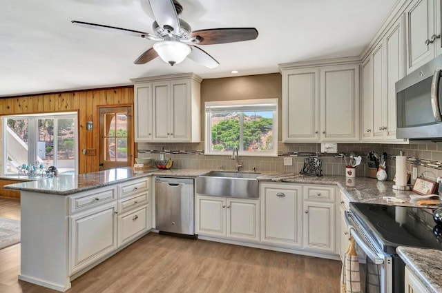 13779 Whispering Meadows Ln, Jamul, CA 91935 - kitchen with appliances with stainless steel finishes, healthy amount of natural light, a peninsula, and backsplash