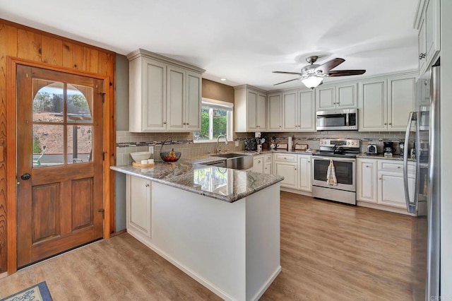 13779 Whispering Meadows Ln, Jamul, CA 91935 - kitchen featuring appliances with stainless steel finishes, a peninsula, backsplash, light wood finished floors, and recessed lighting