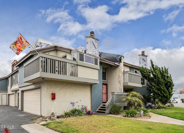 4534 La Brea St, Oxnard, CA 93035 - view of property with an attached garage and asphalt driveway