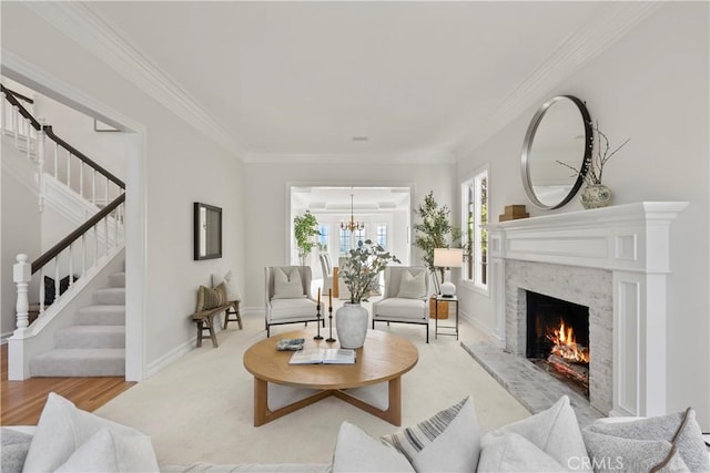 7 Belmont, Newport Beach, CA 92660 - living room featuring stairway, a chandelier, a warm lit fireplace, ornamental molding, and wood finished floors