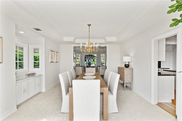7 Belmont, Newport Beach, CA 92660 - dining area featuring a chandelier, a raised ceiling, light carpet, and ornamental molding