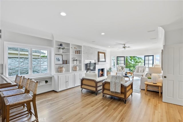 7 Belmont, Newport Beach, CA 92660 - living room with light wood-type flooring, ornamental molding, a fireplace, ceiling fan, and recessed lighting