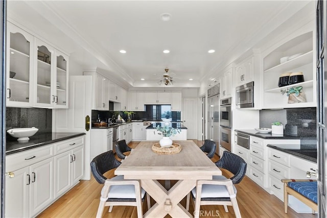 7 Belmont, Newport Beach, CA 92660 - kitchen featuring stainless steel appliances, dark countertops, a warming drawer, backsplash, and white cabinets