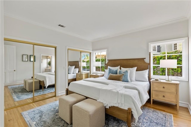 7 Belmont, Newport Beach, CA 92660 - bedroom with two closets, crown molding, and light wood-style floors
