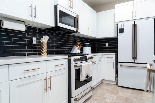 4098 Summer Way, Corona, CA 92883 - kitchen featuring white appliances, white cabinetry, backsplash, stone finish flooring, and light countertops