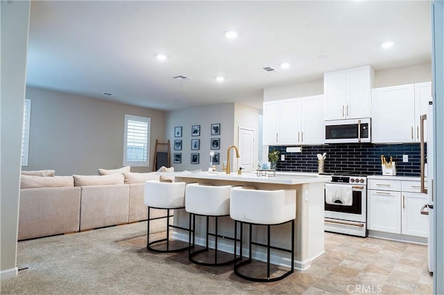 4098 Summer Way, Corona, CA 92883 - kitchen featuring white appliances, light countertops, a breakfast bar area, white cabinets, and recessed lighting