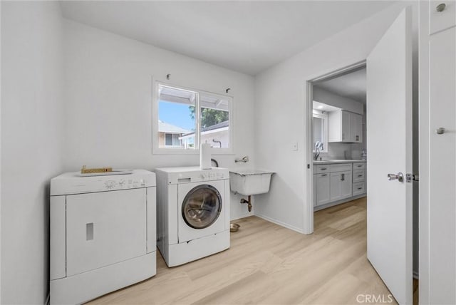 18295 Aguiro St, Rowland Heights, CA 91748 - laundry area with washing machine and dryer and light wood-type flooring
