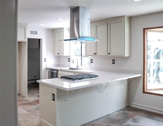 4781 Kona Kove Way, Yorba Linda, CA 92886 - kitchen with wall chimney range hood, appliances with stainless steel finishes, light countertops, a peninsula, and a breakfast bar area
